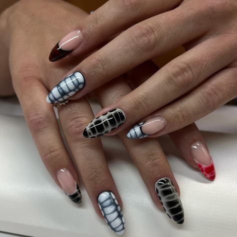 It’s giving Black Widow! 🕷️ A black and white color scheme with some pops of red. Blooming gel was used to create a crocodile pattern across the nails. This is a structured manicure using Luminary Nail Systems “Faith” as the base. Service: Structured Manicure & Art #luminarynailsystems #luminarynails #luminarytech #luminaryfaith #nailtech #naturalnails #naturalstilettonails White And Black Crocodile Nails, Crocodile Nails Black, Black Crocodile Nails, Crocodile Nail Design Red, Black And White Crocodile Nails, Black Blooming Gel Nails, Black And White Blooming Gel Nails, Black Reptile Nails, Crocodile Nails