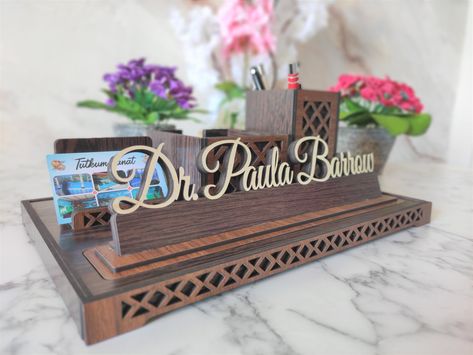 My goal is to design and produce different products. Custom design All-duty Desk Name Plate is made for those looking for something different. Table name plate with Business Card Holder and pen holder It puts an end to the complexity of your desk and allows you to keep your desk organized. Perfect gift for Doctor, Teacher, Realtor, Manager and many more professions. Make your name and title stand out with a special nameplate. Our product is made of 1st class MDF material. Doctor Sign, Name Blocks, Table Name, Desk Name Plate, Desk Name Plates, Table Names, Teacher Name, Business Card Holder, Embroidery Hoop Art