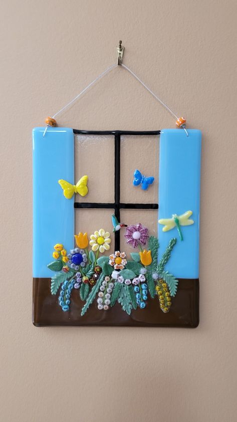 FREE ground SHIPPING for orders $35 and over. Charleston SC Style Window Flower Box Fused Glass Hanger.    Size is 10 inches long x 8 inches tall.  Two drilled holes allow it to be hung where you like.  Two glass beads add a beautiful accent.   This is a heavy piece and should not be hung on a window with a suction cup hanger.  This beautiful flower garden never needs watering and will brighten up any room! Fused Glass Flowers Ideas, Fused Glass Ideas Tutorials, Glass Fusion, Glasfusing Ideas, How To Fuse Glass At Home, Fused Glass Ideas, Fused Glass Ornaments Flower, Glass Fused Sun Catcher, Fused Glass Wall Art Flower