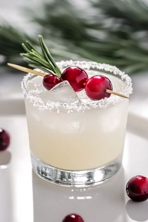 Refreshing White Christmas Margarita with White Cranberry Juice White Xmas Margaritas, White Cranberry Spritz, Drinks With White Cranberry Juice, Winter White Margarita, Frozen Cranberry Margarita, White Cranberry Mimosa, White Cranberry Christmas Cocktail, White Christmas Mocktail, White Christmas Margaritas