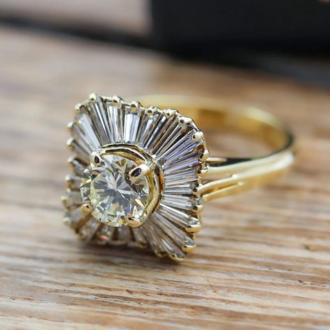 This ring centers a round brilliant cut diamond (1.05ct apx, N-O, VS2) set in 18k yellow gold with a halo of 26 tapered baguette cut diamonds (1.00ctw apx, K-L, VS) – sku: 130-08695 . . . . . . . #vintagejewelry #diamondring #engagementring #showmeyourrings #theknotrings Gemstone Engagement, Baguette Cut Diamond, Baguette Cut, Round Brilliant Cut Diamond, Brilliant Cut Diamond, Round Brilliant, Diamond Cuts, Diamond Ring, Halo