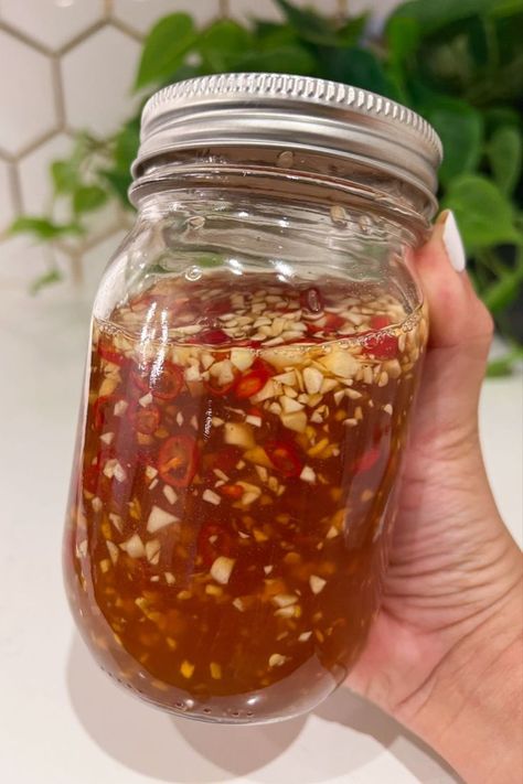 Impress your taste buds with Vietnamese Fish Sauce showcased in a glass mason jar which includes fresh garlic and Thai chili peppers. Egg Roll Sauce, Fish Dipping Sauce, Fish Sauce Recipe, Vietnamese Fish Sauce, Vietnamese Sauce, Picky Bits, Vietnamese Egg Rolls, Vietnamese Salad, Vietnamese Fish