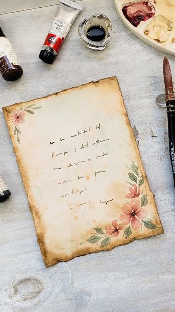 Myno Varela | Botanical Art on Instagram: "Vintage Love Letter 🤎✉️🌸 @artphilosophyco Love, Flowers & Chocolate Party! 👉🏻Tips to get old paper effect: 🩷 torn edges (you can use a ruler or slightly wet the paper and cut with your fingers). 🩷 use brown watercolor with lots of water.  I used AP concentrated watercolor (Cafe).  Saturates the color at the edges. 🩷 add splashes and stains with colors Cafe and Denim. 🩷 you can paint some flowers and voila! Now you are ready to write a letter to Painting On Vintage Paper, Coffee Stained Paper Love Letters, Coffee Paper Letter, Paint On Brown Paper, Design For Love Letter, Love Letter Paper Design, How To Make Vintage Letters, Love Letter Design Ideas, Old Letters Aesthetic