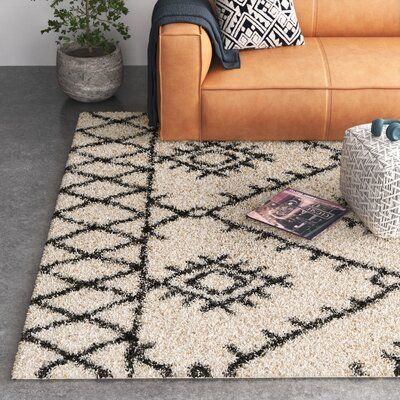 This indoor area rug features a modern twist on a traditional Southwestern-style design, with black-hued geometric shapes that look like carvings upon an ivory background. Its neutral tones complement a variety of styles from rustic to industrial. Power-loomed in Turkey using stain-resistant polypropylene, this plush rug has a high pile height of 1.1". This means it's a great option for low-traffic areas in your home like your bedroom or guest room. It's also safe to place over heated floors. We Ivory And Black Rug, Black Aztec Rug, Black And White Boho Rug, Black And Cream Rug Living Room, Black And White Rug Living Room, Black And Cream Rug, Bedroom Reset, White Rug Living Room, Southwestern Bedroom