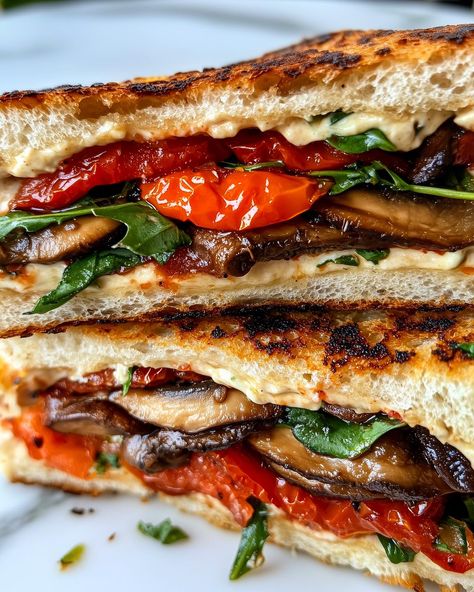 Grilled Veggie & Houmous Sandwich 🥪🌿 Happy national sandwich day! Follow @plantiful.palate for more recipes🗒️ Ingredients: • 2 slices of sourdough bread • 1/4 cup hummus • 1/2 cup cherry tomatoes, halved • 1/2 cup mushrooms, sliced • Handful of fresh spinach or arugula • Olive oil for grilling • Salt and pepper to taste Method: 1. Preheat a pan over medium heat with a drizzle of olive oil. Add the sliced mushrooms and cherry tomatoes. Sauté for 5-7 minutes until the mushrooms are... National Sandwich Day, Mushroom Sandwich, Menu Recipe, Sandwich Day, Fried Tomatoes, Italian Menu, Sourdough Sandwich, Sandwich Wraps, Flat Breads