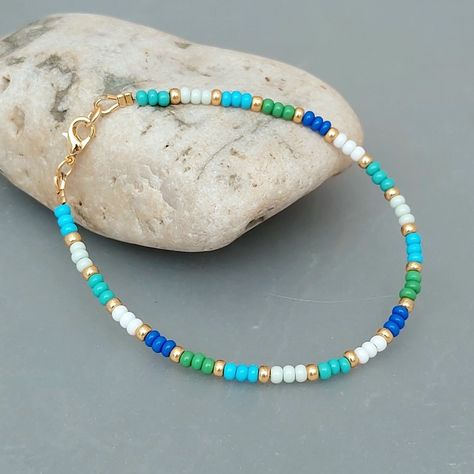 Multicolour Blue Green Seed Bead Bracelet with Gold or Silver Highlights Seed Bead Jewellery, Collar Verde, Tiger Tail, Green Beaded Bracelets, Bead Suppliers, Blue Beaded Bracelets, Blue Green Gold, Seed Bead Bracelet, Bead Ideas