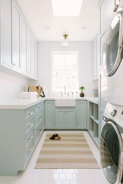 Blue green u-shaped laundry room boasts a beige striped rug placed on white hex floor tiles beneath a skylight. Grey Laundry Room Ideas, Madison Ct, Laundry Room Storage Shelves, White Laundry Rooms, Green Laundry, Room Storage Diy, White Laundry, Mudroom Laundry Room, Laundry Room Inspiration