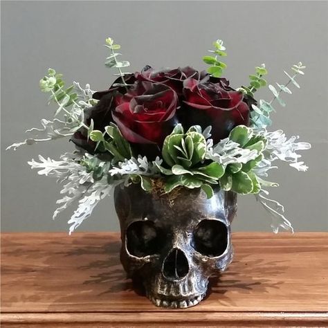 a bronze skull vase with eucalyptus, greenery and deep colored roses as a Halloween centerpiece Graduation Money Bouquet, Money Rose Bouquet, Resin Keepsake, Skull Vase, Nyc Florist, Skull Planter, Money Rose, Halloween Themed Wedding, Graduation Money