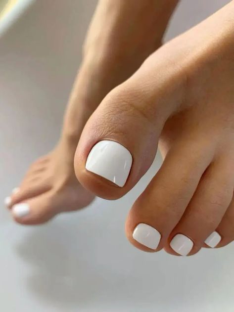 Discover the latest trends in spring toe nail colors for 2024, perfect for fashion-forward women aged 25-55. This guide showcases stylish pedicure ideas, from matte mauves and sparkling pastels to bold ombre and solid tangerine hues. Embrace 2024's gel polish, dip powder, and acrylic options for a fresh, bright look. Find your next pedicure inspiration with almond, neon, and multi-colored trends that promise to elevate your style and make a statement this season. Whether you prefer light pastels Spring Toe Nail Colors, Toe Nail Colors, White Pedicure, Colors For 2024, Fake Nail Tips, Pedicure Colors, Toe Polish, Gel Toe Nails, Toe Nail Color