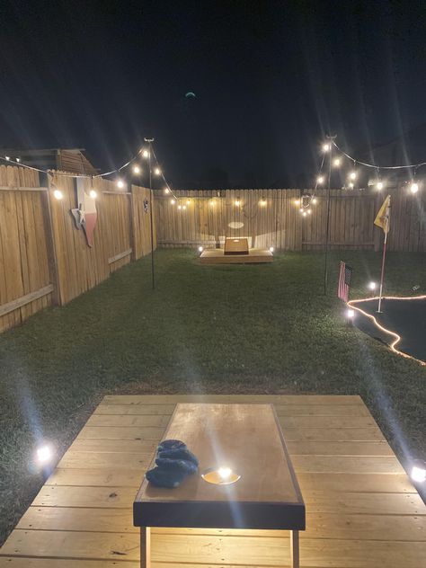 Backyard Diy Firepits, Cornhole Patio Ideas, Fire Pit And Picnic Table Area, Cornhole At Night, Back Yard Games Outdoor, Diy Camp Fire Pit, Outback Patio Ideas, Corn Hole Yard Designs, Backyard Yard Game Area