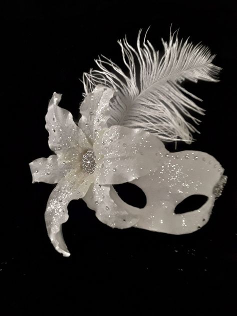 Masquerade Mask , Bridal Mask, Wedding Photo Prop, Ballroom Mask, Mardi Gras, Handmade Mask Handmade one of a kind paper mache mask. Covered with white bridal satin fabric then embellished with clear glitter that adds a sparkle as you walk across the room. I added a large white lilly on right side of mask which is adorned with large crystales and matching glitter. I followed across top of mask with large matching crystals which meet with a large rhinestone brooch in the form of flowers. Tucked b Ballroom Mask, Masquerade Aesthetic, White Masquerade Mask, Silver Masquerade Mask, Wedding Photo Prop, Paper Mache Mask, Black Tie Attire, Bridal Mask, Handmade Mask