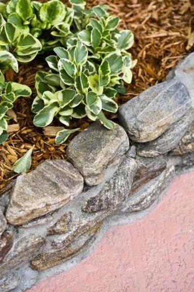 Faux, or fake, rocks are sold by garden centers and used in landscaping, including to make fire pits, stepping stone paths and walls. Made of concrete, polymers and other materials, faux rocks are just as sturdy as natural rocks, yet, in some cases, are lighter and easier to handle. Curved or slightly angled faux ... Brick Raised Beds, Shed Inspiration, Raised Flower Bed, Building A Stone Wall, Rock Flower Beds, Landscaping Blocks, Building A Retaining Wall, Faux Rock, Raised Flower Beds