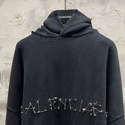 mfw on Instagram: "New: Safety Pins Hoodie & T-Shirt from Balenciaga Winter24  Large fit Inspired by a DIY aesthetic, these pieces are characterized by their use of safety pins to spell out ‘Balenciaga’ Distressing and fading is found throughout the garments, giving them the appearance of heavy usage  A similar concept can be seen on the ‘Tape Type’ pieces from Summer23, the logo being spelled out with tape artwork  Photos are mine  #demna #demnagvasalia #balenciaga" Demna Balenciaga, Clothing Brand Inspiration, Balenciaga Aesthetic, Graphic Hoodies Aesthetic, Balenciaga Hoodie, Fit Inspired, Essential Clothing, Painted Clothes Diy, Balenciaga Clothing