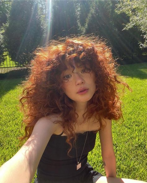 Curly Dark Ginger Hair, Ginger Curly Hair With Bangs, Copper Red Hair Curly, Dark Orange Curly Hair, Curly Hair Covering Eyes, Red Curly Hair Natural, Curly Red Hair With Bangs, Red Dyed Curly Hair, Curly Red Hair Naturally