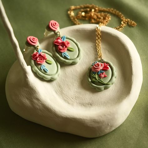 Introducing my latest polymer clay creation: a delicate set of earrings and a pendant adorned with intricate floral details! Each piece is carefully sculpted by hand, featuring soft pastel greens, pinks, and reds that give off a romantic, vintage vibe. Perfect for adding a touch of elegance to your everyday look or as a special gift. 🌿💖 ✨ Lightweight, comfortable, and one-of-a-kind! Earrings and pendant available as a set or individually. DM for Customisation 🌸 #from34crafts, #polymerearri... Vintage Clay Earrings, Clay Embroidery, Kawaii Items, Schmuck Diy, Polymer Clay Jewelry Diy, Clay Jewelry Diy, Polymer Clay Creations, Vintage Vibe, Pastel Green