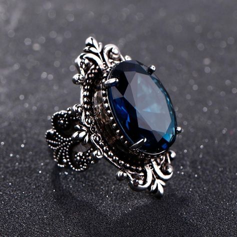 This gorgeous sterling silver ring is perfect for a person with a flare for vintage jewelry. The Blue Sapphire Peacock Vintage Ring features an oval blue sapphire as its centerpiece, encircled by small round white diamonds that catch the light gloriously and radiate life! From cornflower blue to velvety blue, there are multifarious shades of blue sapphire that gives it a silky tint. Characterized by the power of Shani or Saturn, Blue Sapphire displays violet to indigo and pale blue as well as da Sapphire Silver Ring, Pattern Ring, Men Vintage, Blue Sapphire Rings, 925 Jewelry, Types Of Rings, Rings For Women, Blue Rings, Topaz Ring