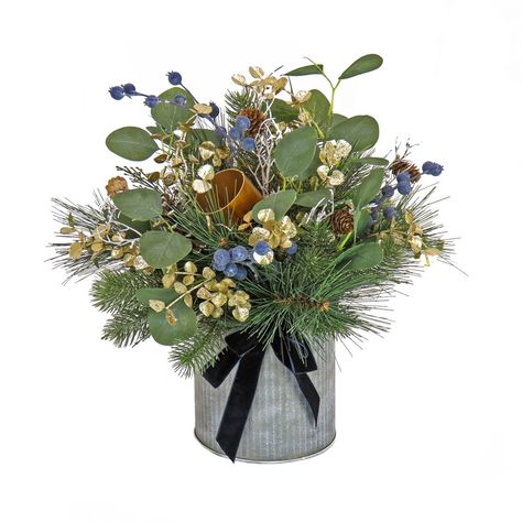 This Swiss Chic decorative arrangement features a mixture of evergreen and bristle branch tips tightly grouped together and seated in a round metal pot base. Other trimmings include pinecones, leafy greens, white twigs, clusters of blue berries and gold metal bells. A black velvet ribbon and bow add the finishing touch. This unique tabletop piece will add a touch of festive greenery to your holiday decorating scheme. For indoor display only. Winter Floral Arrangements Home, Communion Table, Plant Arrangement, Artificial Plant Arrangements, Black Velvet Ribbon, Blue Berries, Hydrangea Arrangements, Christmas Plants, Artificial Potted Plants