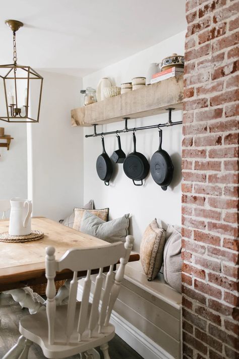 Cast iron skillets hanging on a black steel pipe shelf. Cast Iron Skillet Storage Wall, Ways To Hang Cast Iron Skillets, Open Wall In Kitchen Ideas, Cast Iron Hanging On Wall, How To Hang Cast Iron Skillets On Wall, Cast Iron Hanging Ideas, Hanging Cast Iron Pans The Wall, Cast Iron Skillet Storage, Cast Iron Skillet Storage Ideas