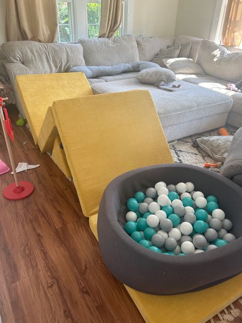 This is perfect if your toddler is in thr stage of climbing. This is perfect for the winter when you cant go outside or when the summer days are too hot to stay outside all day. Nugget Ball Pit Build, Diy Foam Ball Pit, Playroom With Foam Pit, Nugget Couch Ball Pit Build, Nugget Couch Ideas, Nursery Ball Pit, Ball Pit For Babies, 1 Nugget Couch Ideas, Nugget Configurations