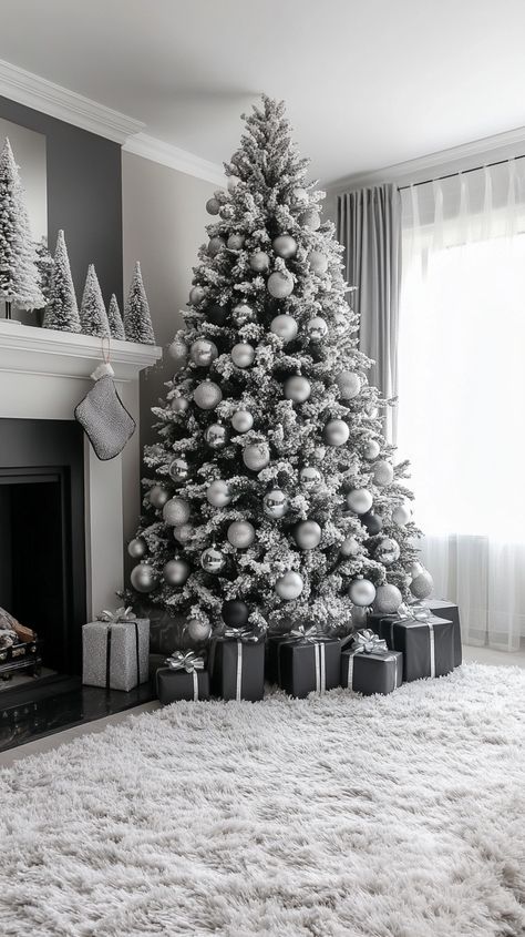 Elegant black and white Christmas tree with silver ornaments, surrounded by a cozy living room and black gift boxes Christmas Tree By Fireplace, White Glam Christmas Tree, Glam Christmas Tree Ideas, Living Room Backdrop, White Fluffy Rug, Black And White Christmas Tree, Grey Christmas Tree, Room Backdrop, Glam Christmas Tree