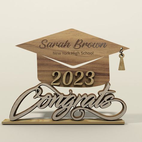 Looking for a unique and personalized way to celebrate the Class of 2023's graduation? Look no further than this beautiful wooden graduation gift, perfect for college graduates of all genders. Standing at 4 inches tall and 5 inches wide and crafted from high-quality, natural wood, this graduation gift is designed to last a lifetime, serving as a cherished keepsake for years to come. Each piece is carefully customized with the graduate's name, school, and graduation year, making it a truly unique Graduation Designs Ideas, Glowforge Ideas, Jean Collection, Custom Graduation Caps, Graduation Design, Graduation Gifts For Him, Router Machine, Laser Cut Patterns, Graduation Year