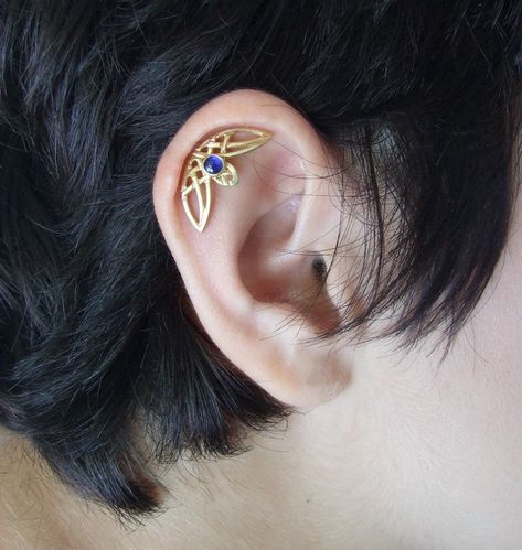 "This is a single helix piercing with intertwining Celtic designs. It comes as a single ear piercing, and fits both ears. It is made of 14k gold and stamped 14k on the backside. You can choose yellow, rose, or white 14k gold plating when you order. I plate the white gold with rhodium plating, as common in white gold jewelry. You can also choose the finish you want for the earring - matte ( as seen in pictures ) or shiny. In the pictures, you can see the earring with a blue topaz stone, which is Pretty Helix Earrings, Helix Jewelry Cartilage Piercings, Curved Helix Earring, Hidden Helix Jewelry, Single Helix Piercing, Single Ear Piercing, Hidden Helix Piercing, Gold Helix Earrings, Septum Piercing Jewelry