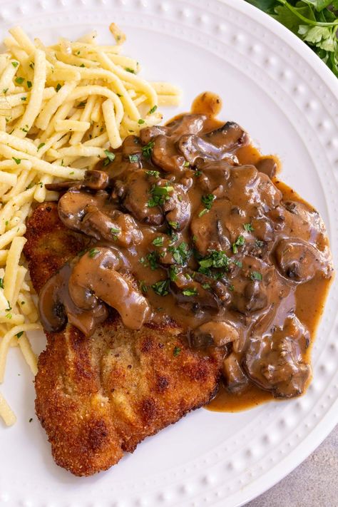 Jägerschnitzel, or Hunter’s Schnitzel, is a popular German dish of fried pork cutlets topped with luscious mushroom gravy. With a crispy crust and tender, juicy interior, schnitzel just can’t be beat. Finishing it with a classic jägersoße (hunter’s sauce) is one of the best ways to enjoy it! German Schnitzel With Mushroom Gravy, Hunters Gravy, Schnitzel Gravy Recipe, Fried Pork Cutlets, Easy Italian Meatloaf, Jaeger Schnitzel, Pork Schnitzel Recipe, Brown Gravy Recipe, German Food Authentic