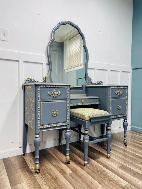 Beautiful vintage / antique vanity finished in a gray/light blue paint and silver and gold gilding wax, the gold transfer scene just made this vanity special. Will find its place in any home decor you will love this one. H: 30.5 W: 47 D : 18 Free Shipping--- Free shipping in a 50 mile radius from Garfield NJ. If you are outside of our local shipping offer, contact me for a shipping quote. We use a few long distance shippers that specialize in painted furniture moving with a 3 to 5 day delivery window We have it listed locally and it will sell quickly All of the furniture that we sell go through an extensive cleaning process and it is inspected for any structural damage. If damage is found it is repaired to make sure that no further damage happens and return its functionality to where the m Diy Painted Vanity, Yard Aesthetic, Light Blue Paint, Restoring Furniture, Birthday 25, Handmade Wood Crafts, Vintage Furniture Makeover, Vanity Tables, Light Blue Paints