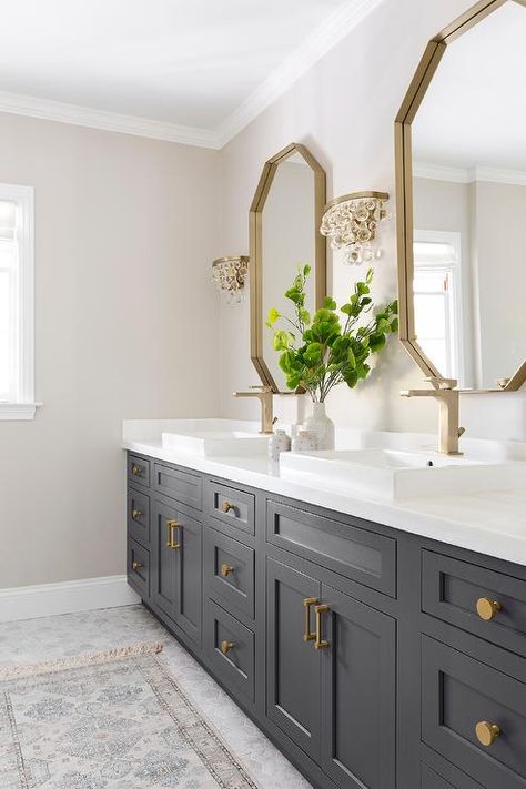 Glass droplets sconces flank a gold mirror over a black bath vanity accented with brass hardware and a brass faucet fixed above an overmount sink. Makeover Kamar Mandi, Vanity Ideas, Entrance Foyer, Master Bath Remodel, Foyer Design, Bathroom Remodel Shower, Lodge Decor, Upstairs Bathrooms, Bathroom Renos