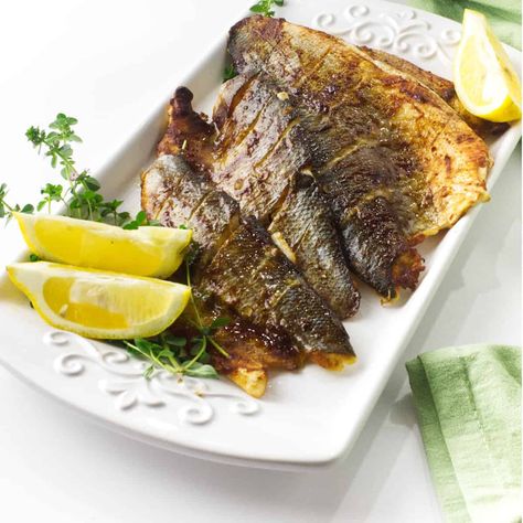 Miso Baked Branzino is a healthy, easy, and delicious dish that will please seafood lovers of all ages. This dish is perfect for a weeknight meal because it only takes minutes to prepare and the oven does all the work! The Branzino is glazed with a miso sauce which gives it a wonderful depth of flavor. Bronzino Recipe, Baked Branzino Recipe, Baked Branzino, Branzino Recipe, Filet Recipes, Miso Sauce, Oven Roasted Asparagus, 30 Minute Meals Easy, Northern Africa