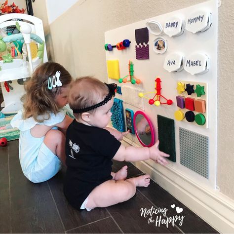 Dollar Store Busy Board – Noticing the Happy Infant Activity Board, Infant Busy Board Diy, Wall Mounted Busy Board, Busy Board For 1 Year, Homemade Busy Board, Montessori Busy Board Diy, Baby Activity Board, Diy Busy Board, Busy Board Baby