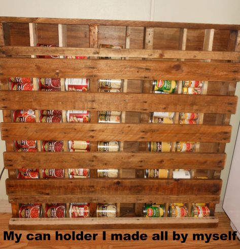 I made my own can storage rack from an old pallet.... After I took off the back boards, I put a piece of paneling on it . Put in more 1 x 4's  to make separate bins for dif veggies. It def freed up space in my pantry. Then I did a little sanding and staining and there ya go. It does have a free space for really small cans. I think I will put wheels on it and slide it behind an appliance out of the way. Diy Can Storage, Canned Food Dispenser, Pallet Pantry, Canned Good Storage, Wooden Pantry, Repurpose Pallets, Pallet Crates, Canned Food Storage, Pallet Projects Furniture