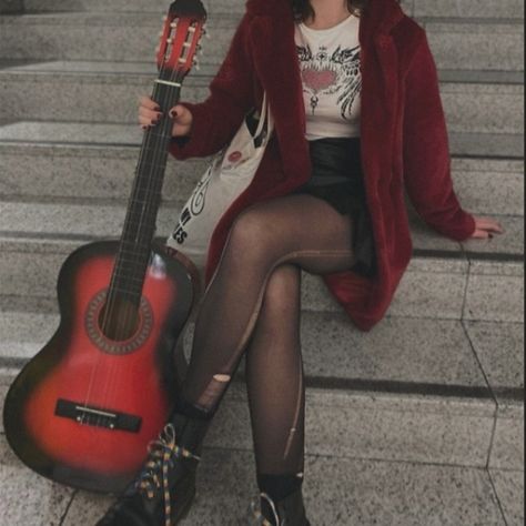 Girl sitting on stairs while holding a red guitar. She's waring a red fur coat with a black leather skirt and ripped tights. Body And Style Style Roots, 90s Pop Punk Aesthetic, Rockstar Outfits Aesthetic, Red Fits Aesthetic, Female Rockstar Aesthetic Outfits, Grunge Rockstar Aesthetic, Rock Aesthetic Outfits, Rockstar Aesthetic Outfits, Rocker Aesthetic