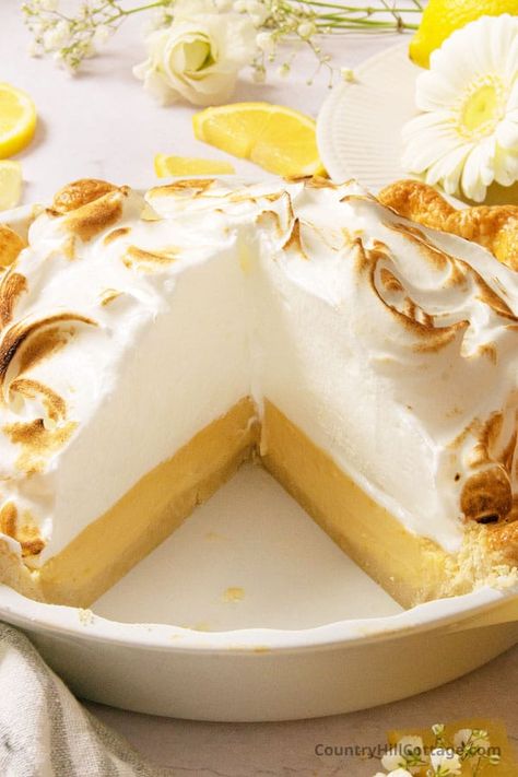 Homemade lemon meringue pie with condensed milk is a slice of sunshine made with only 6 ingredients! A creamy zesty lemon custard filling with sweetened condensed milk rests in a buttery pie crust and is topped with a mound of fluffy, toasted no-weep meringue. An easy make-ahead dessert recipe for Thanksgiving, holidays, and special occasions! You can also try a graham cracker crust, top the pie with whipped cream, or use limes or grapefruits instead of lemons. | CountryHillCottage.com Lemon Pie With Meringue, Lemon Meringue Pie With Condensed Milk, Condensed Milk Lemon Meringue Pie, Lemon Ice Box Pie Recipe Condensed Milk, Lemon Meringue Pie Recipe Condensed Milk, Freezer Pies, Lemon Pie Recipe Condensed Milk, Lemon Custard Filling, Homemade Lemon Meringue Pie