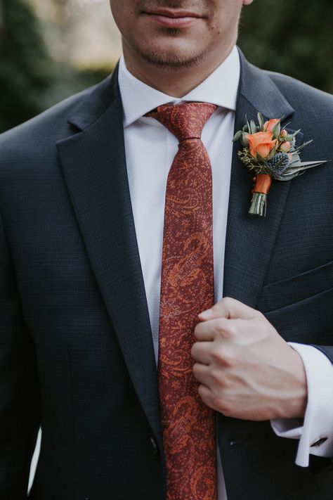 Burnt orange tie and thistle boutonnière Mens Ties For Fall Wedding, Burnt Orange Floral Tie, Fall Ties For Wedding, Fall Floral Tie Wedding, Father Of The Bride Attire Terracotta, Terracotta Floral Tie, Navy Suit Burnt Orange Tie, Burnt Orange Buttonhole, Navy Suit Terracotta Tie