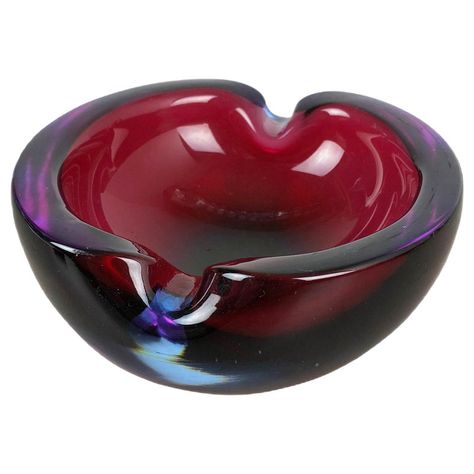 Article: Murano glass bowl, ashtray element Origin: Murano, Italy Decade: 1970s This original vintage glass bowl element, ash tray was produced in the 1970s in Murano, Italy. It is made in Sommerso technique and has a fantastic faceted form. The vibrant color makes this items highly decorative. This item is a high production of Murano glass producer and very unique in its coloration mixture of dark red, blue, purple tone. Pretty beautiful to be used as jewelry bowl, vide-poche or ashtray or to d Shell Ashtray, Crystal Glassware Antiques, Vintage Glass Bowl, Jewelry Bowl, Purple Tone, Puff Puff, Murano Italy, Ash Tray, Vintage Ashtray