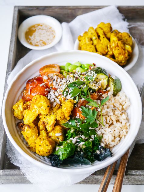 Roasted Turmeric Cauliflower Buddha Bowls make such a colourful, healthy meal! This vegan and gluten free recipe is easy to make and flexible. by Nourish Everyday Macro Bowl Recipe, Vegan Buddha Bowls, Buddha Bowl Recipes, Macro Bowl, Filling Meals, Turmeric Cauliflower, Buddha Bowls Recipe, Vegan Buddha Bowl, Riced Cauliflower