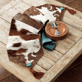 Cowhide and Turquoise Table Runner A Black Forest Decor Exclusive - Genuine tri-color hair-on cowhide is accented with high-quality tooled leather and is trimmed with deerskin lacing and tassels and genuine turquoise stones on the Cowhide and Turquoise Table Runner Rustic Bedrooms, Western Bedding Sets, Cowhide Decor, Cowhide Furniture, Rustic Cabins, Turquoise Table, Western Bedding, Cabin Furniture, Black Forest Decor