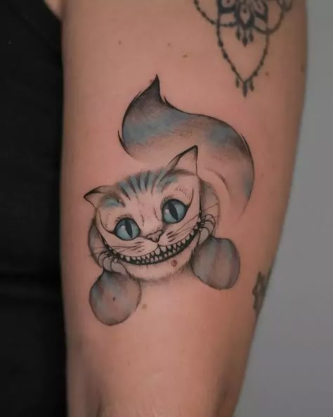 48 Stunning Cheshire Cat Tattoo Ideas You Must Try In 2024 Creepy Cheshire Cat Tattoo, Mad Hatter And Cheshire Cat Tattoos, Cat From Alice In Wonderland Tattoo, Cheshire Cat Tattoo Design, Crazy Cat Tattoo, Cheshire Cat Tattoos, Chester Cat Tattoo, Alice In Wonderland Tattoo Cheshire Cat, Alice In Wonderland Cat Tattoo