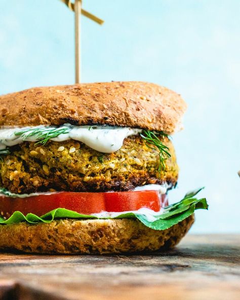 This insanely good falafel burger is easy to make and bursting with Mediterranean flavor! Smother in sauce for an epic vegetarian or vegan dinner. This healthy dinner recipe takes 45 minutes or less to cook and is perfect for those warm summer evenings. #vegan #vegetarian #falafel #veggieburger #burger #recipe Falafel Burger, Falafel Burgers, Best Veggie Burger, Falafel Sandwich, A Couple Cooks, Veggie Burgers Recipe, Homemade Tzatziki, Baked Avocado, Vegetarian Cookbook