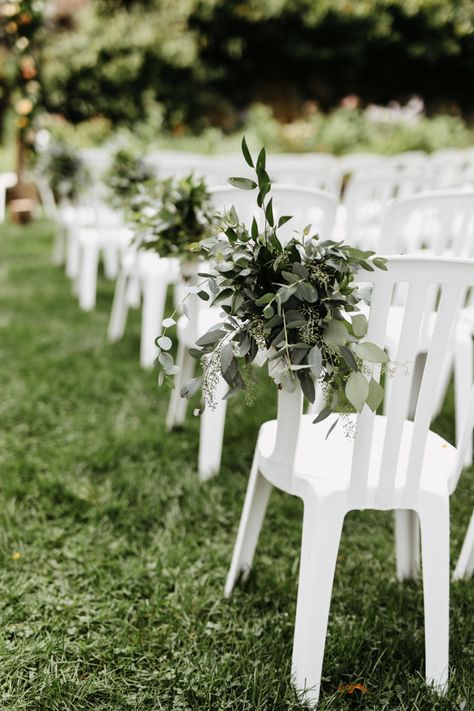 Wedding Plastic Chair Decorations, Plastic Wedding Chairs, Plastic White Chairs Wedding, Plastic Chair Wedding Ceremony, Aisle Garden Wedding, Simple Isle Decorations Wedding Outdoor Ceremony, White Chair Decor, Outdoor Wedding Chairs Ceremony Seating Aisle Decorations, Asile Wedding Ideas Outdoor