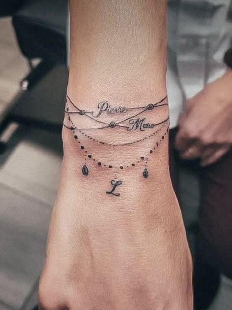 Bracelet Tattoos With Names, Wrist Bracelet Tattoo, Wrist Tattoo Cover Up, Wrist Tattoo Ideas, Tiny Wrist Tattoos, Hand And Finger Tattoos, Tattoo Name, Mommy Tattoos, Tasteful Tattoos