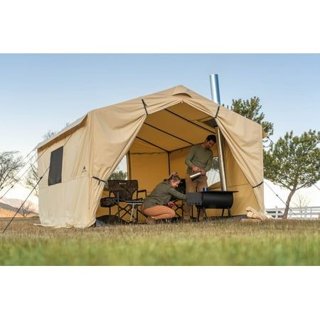 Get this Ozark Trail North Fork 12' x 10' Wall Tent for your outside exploring needs. It is convenient whether there's rain, sleet or snow. The canvas-imitation fabric on this wall tent with a stove jack wraps around a frame with adjustable legs and eaves to place it on uneven ground. Setup is easy with the color-coded poles and hubs, while a removable PVC floor keeps you dry from underneath. Fit your heat source in the outdoor tent, with its integrated section that fits pipes up to 5" in diamet Tent Kitchen, Hot Tent Camping, Campsite Setup, Tent With Stove, Canvas Wall Tent, Window Storage, Survival Tent, Hot Tent, Tent Living