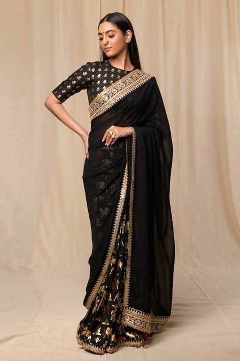 Black oasis print saree with sheer palla, embellished with embroidered border and tassel. Comes with black wallflower print blouse piece. Components: 2 Pattern: Print Type Of Work: Oasis, Wallflower Fabric: Raw Silk, Organza Color: Black Other Details:  Embroidered borders Tassel edged palla Unstitched blouse piece: 1 metre Raw Silk Note: The stitched blouse worn by the model is not for sale Disclaimer: The actual print-placement of the product may vary slightly from the image shown. Occasion: C Black Organza Saree, Caribbean Fashion, House Of Blouse, Raw Silk Fabric, Print Saree, Embroidered Border, Black Saree, Lakme Fashion Week, Organza Saree