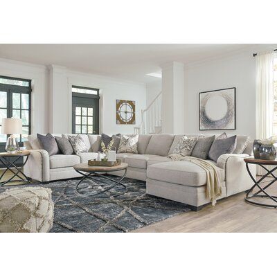 Looking for a “transitional” look that’s as comfortable in contemporary spaces as it is in classic surroundings? Rest your eyes on the beauty of this 5-piece sectional. Soft, tight woven texture with chalky beige hue is so in the now. Gracefully curved arms punctuated with oversized nailhead trim infuse a sense of everyday elegance. | White Sectional - Signature Design by Ashley Dellara 129" Wide Symmetrical Corner Sectional Polyester | 38 H x 129 W x 125 D in | Wayfair Furnitur Ruang Keluarga, Sofa L, Upholstered Sectional, Living Room Sectional, A Living Room, Ashley Furniture, Small Living Room, Rustic Furniture, Living Room Sets