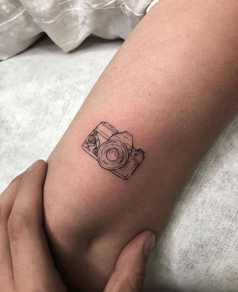 The Art of Travel: Exploring the World of World Traveler Tattoos | Travel Tattoos Inspo Arm Tattoo Photography, Cute Camera Tattoo Ideas, Small Tattoos Photography, Small Tattoos Camera, Vintage Camera Tattoo Design, Photography Tatoos Ideas, Photo Camera Tattoo, Camera Minimalist Tattoo, Camera Outline Tattoo