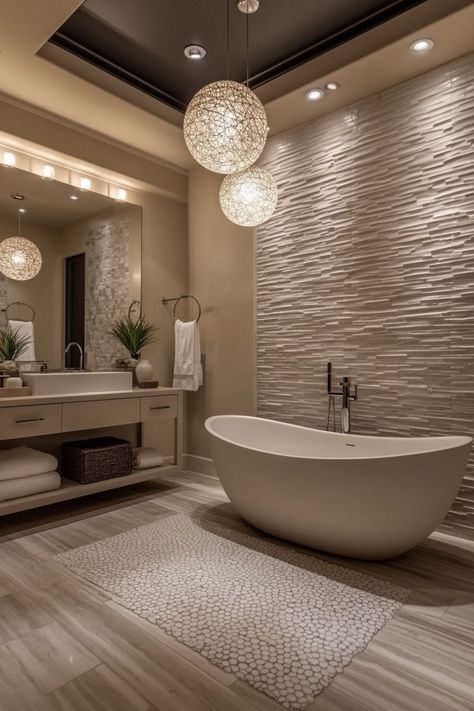 Create a spa-like retreat in your home with luxury bathroom decor. Opt for high-end materials like marble countertops, brass fixtures, and natural stone tiles. Incorporate freestanding tubs, rain showers, and heated floors for added comfort and indulgence. Use plush towels, elegant accessories, and soft, ambient lighting to enhance the lavish feel. A chandelier or statement lighting above the tub adds an extra touch of opulence. 🛁✨ Dark Grey Master Bath, Elegant Bathroom Ideas Luxury, Bathroom Feature Tile, Spa Bathroom Ideas Master Bath Decor, Large Bathroom Ideas, High End Bathroom Design Luxury, Luxury Bathtubs, Dream Bathroom Luxury, High End Bathroom