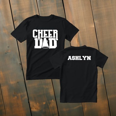 Custom Cheer Dad Shirt Make a statement of support with our custom cheer dad t-shirts! Available in various colors and sizes, these shirts are designed to be a perfect fit for any cheer dad. Personalize it with their name to make it truly one-of-a-kind. Wear it to cheer events, practices, or simply around town, and showcase your love and pride as a cheer dad! *Deets* *This custom shirt is handmade with professional vinyl. *Our shirts are unisex and are true to size! *In the photo's you will be able to see the custom options in regards to color that you may choose from. *We use 100% cotton shirts. The glitter material does not wash off and will last through multiple washes.  *If your shirt color is out of stock we will contact you as soon as possible to see if you would like to change shirt Cheer Parent Shirts Design, Dad Shirt Ideas, Cheer Mom And Dad Shirts, Cheer Dad Shirt Ideas, Customizable Casual T-shirt For Cheerleading, Cheer Dad Shirt, Custom Print T-shirt For Cheerleading, Cheer Dad Shirts, Cheerleading Picture Poses