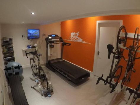 The pain cave essentials - Triathlon Magazine Canada Triathlon Strength Training, Zwift Cycling, Triathlon Training Program, Triathlon Tattoo, Triathlon Training Plan, Gym Designs, Bicycle Garage, Home Gym Ideas, Cycling Studio