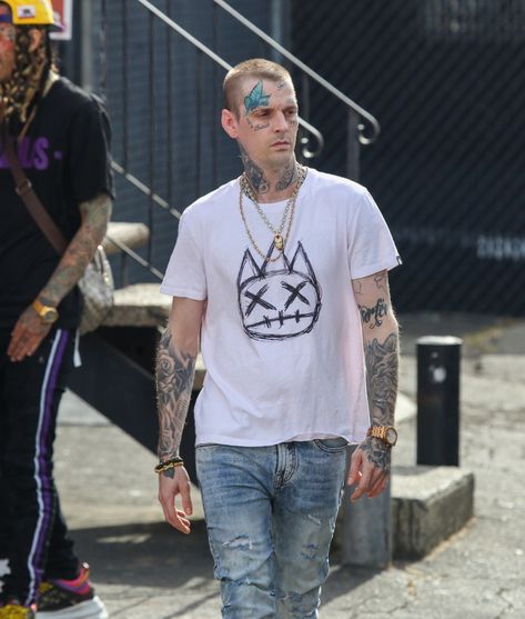 Aaron Carter looks unrecognizable with a shaved head and more tattoos in new pictures. The shocking new look comes just three months after the singer’s split from his once-fiancée Melanie Martin. Pictured arriving to play a gig in Los Angeles, Aaron, 34, was photographed with a shaved head. In a radical style departure, his old […] Prince Lyrics, Aaron Carter, Sports Celebrities, Chris Rock, Nick Carter, Die Young, Shaved Head, Backstreet Boys, Pop Singers